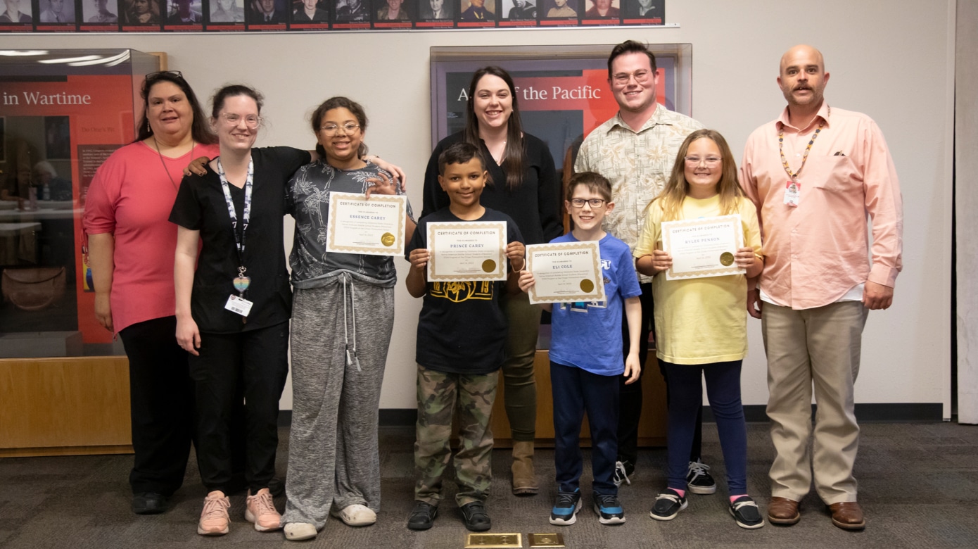 Students and staff from CPN's after-school program pose for a photo following a recent ceremony commemorating the end of a new program that brought digital design technologies to Native students. Each student holds a certificate of completion.