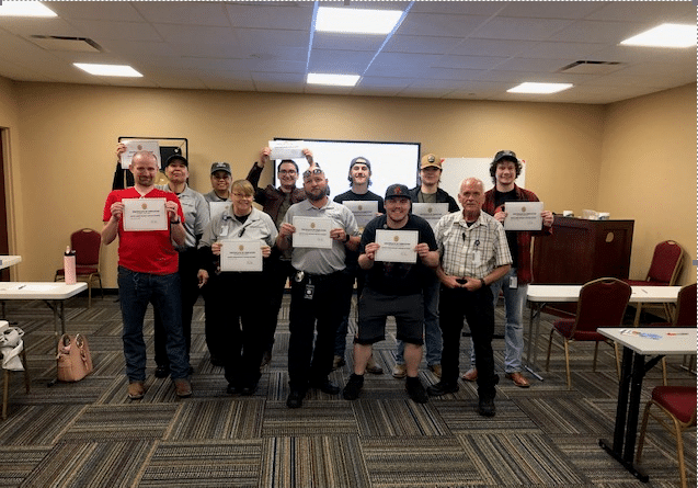 A group of security officers pose with their certificates of completion following a security training class at the Grand Casino.