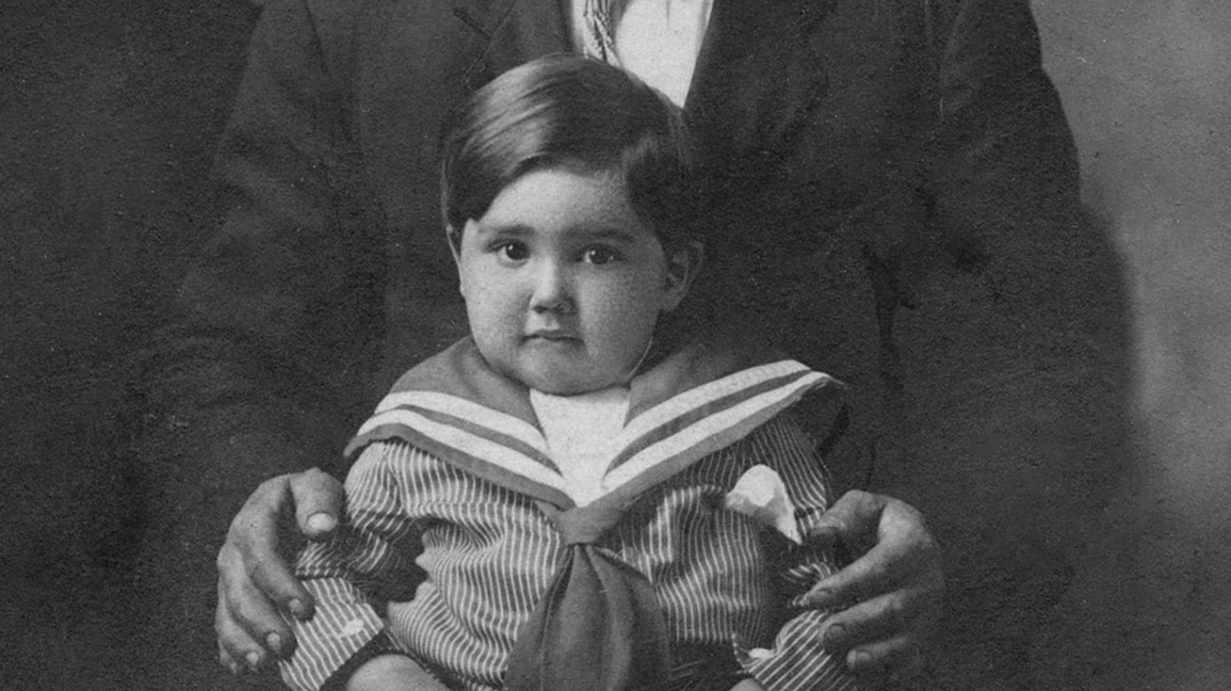 Irene Whitehead Pecore, standing; Ed Pecore, seated in front of Irene, and holding child Autwin B. Pecore.