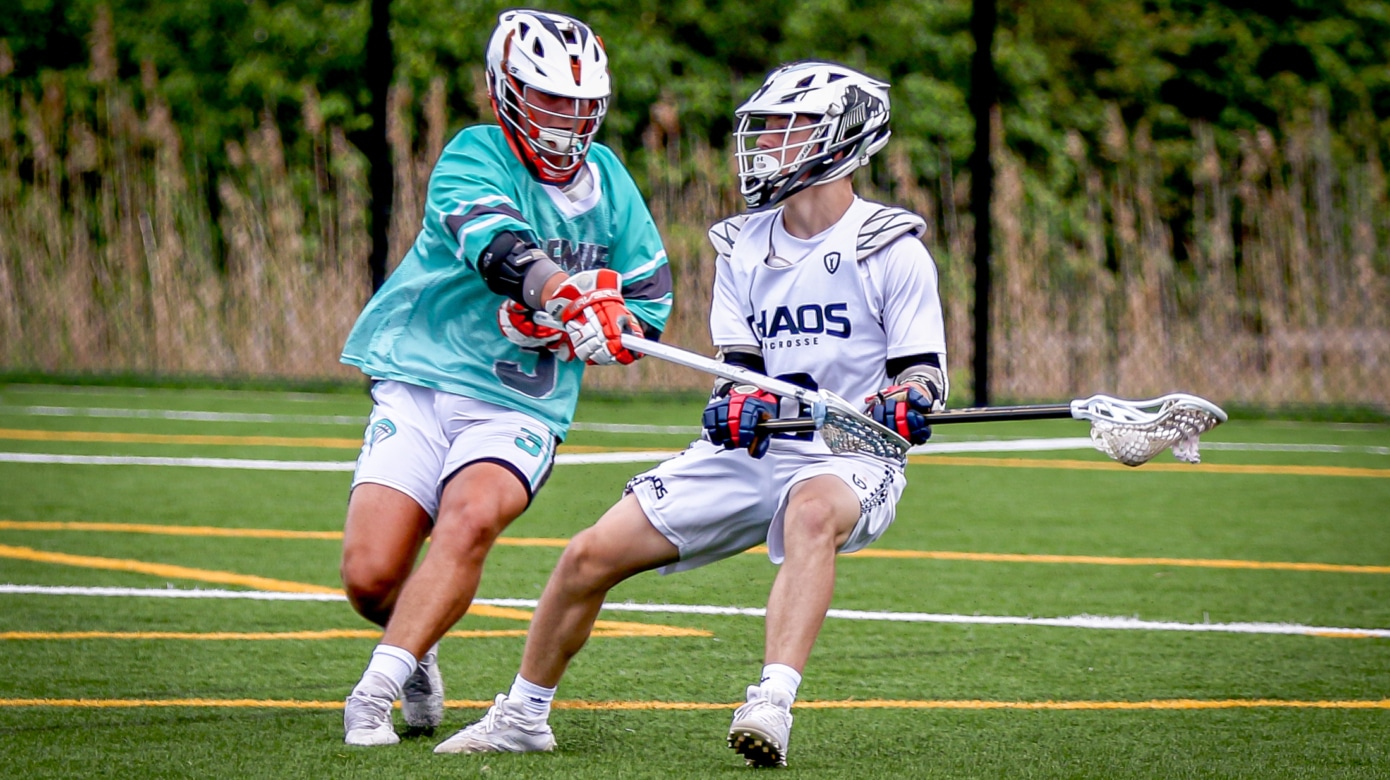 Chase Peltier, in a white lacrosse uniform, and a player in a teal jersey are photographed in action mid-game.