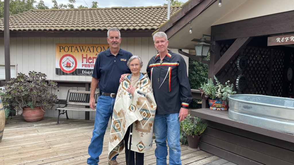 Furthest travelled at a recent gathering stands wrapped in a Pendleton blanket next to District 6 Legislator Rande Payne and District 7 Legislator Mark Johnson.