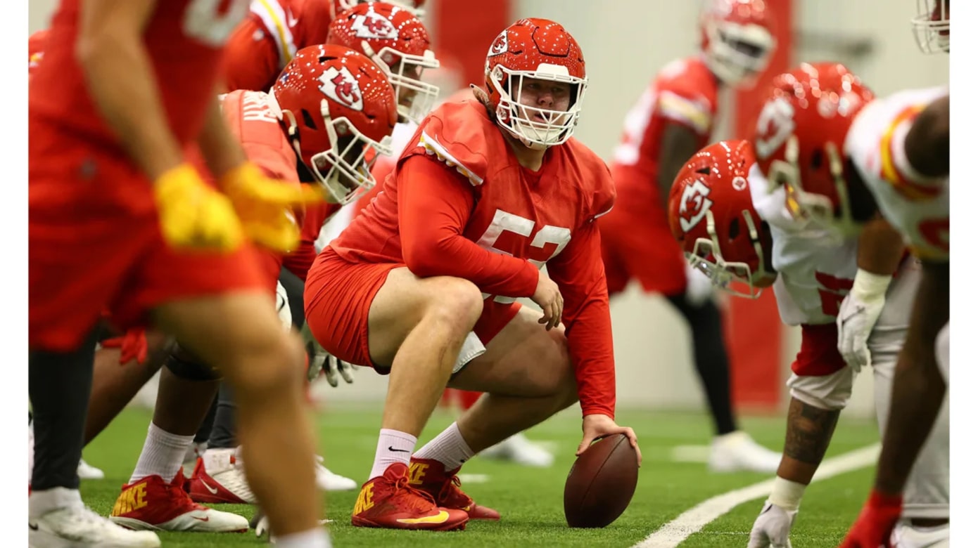 Football practice photo from the Kansas City Chiefs' Dec. 15, 2022, practice. The focus is on center Creed Humphrey, who looks up before snapping the ball to the quarterback.