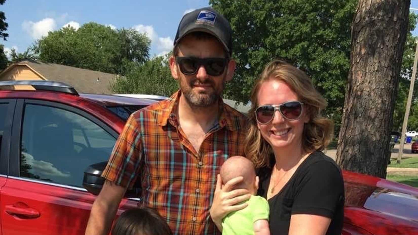 The Dunigan family of four poses for a photo on a sunny day.