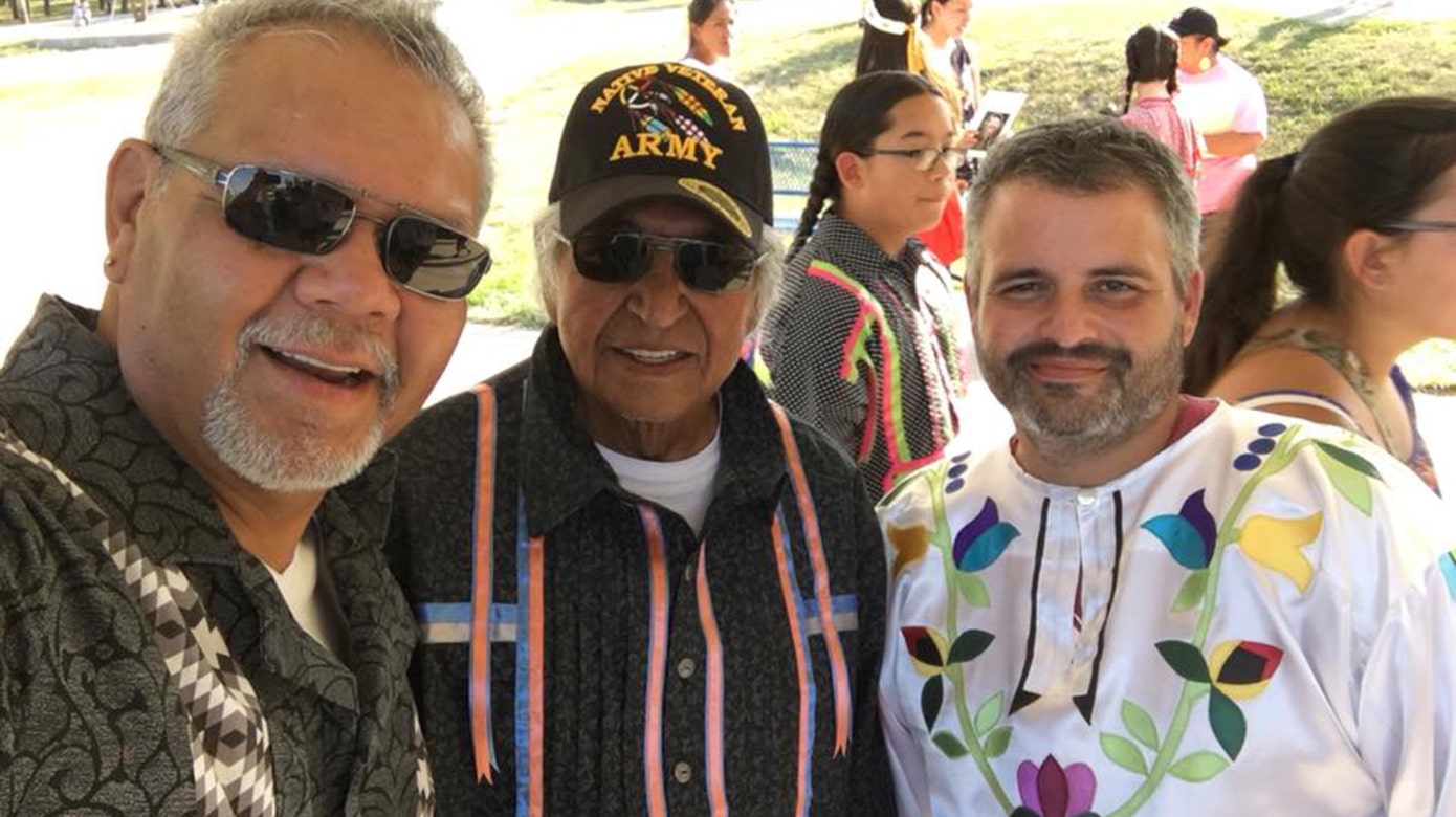 A selfie of Ken Meshigaud, Jim Thunder, and CPN Language Director Justin Neely wearing ribbon shirts and sunglasses at the 2018 Potawatomi Gathering in Kansas.