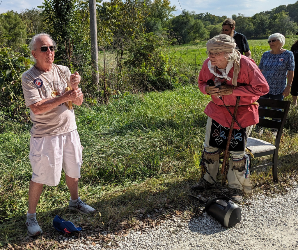 Bob Whistler stands, left, and George Godfrey, right, blessing a site on the side of a road on the Potawatomi Trail of Death Caravan in 2023.