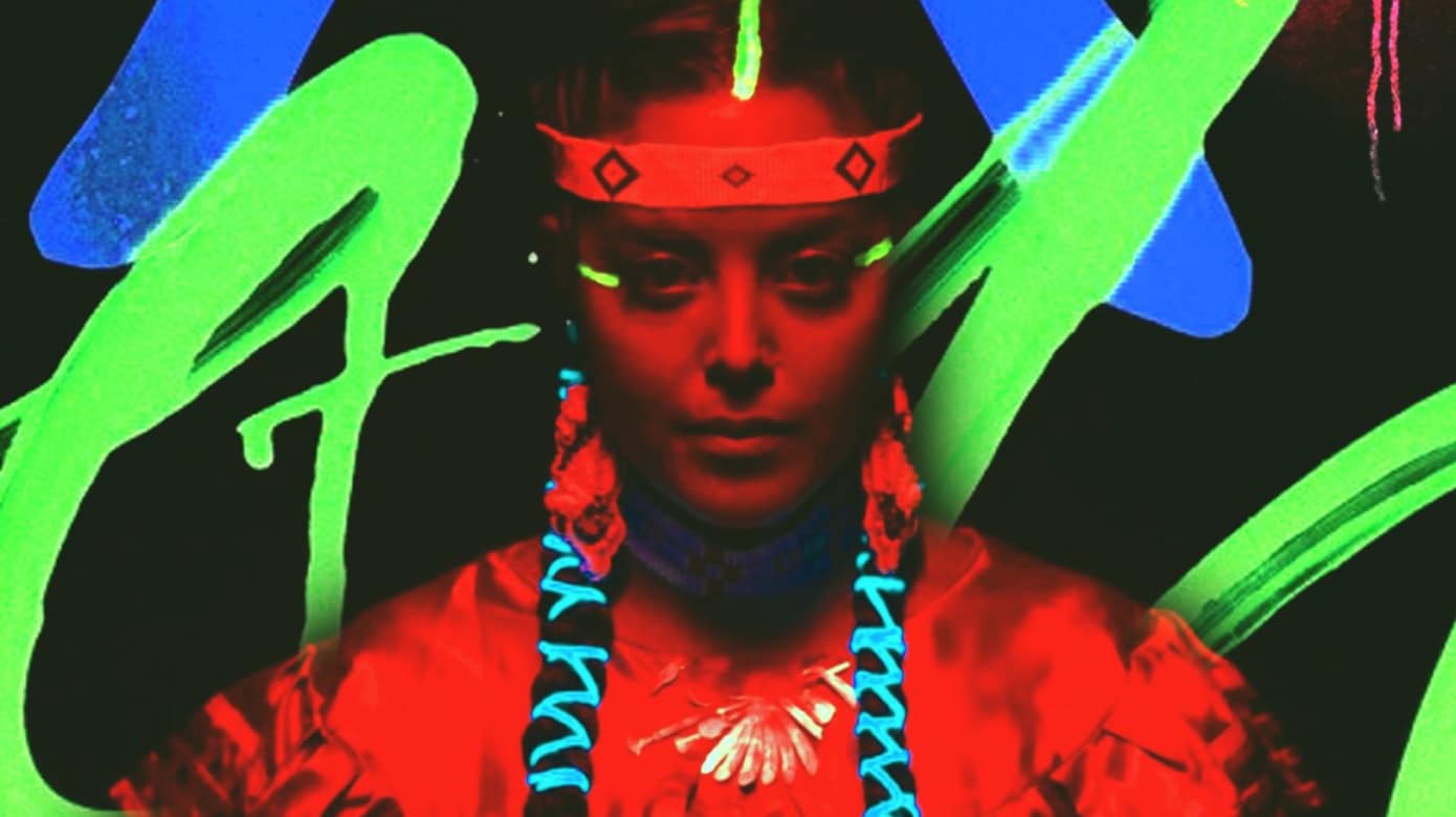 A headshot of a woman in regalia looking straight at the camera. The shot is lit with red light and there are red, blue, and bright green markings surrounding the figure.