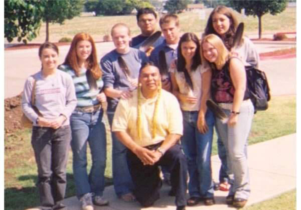 A slightly grainy photo from 2003 of eight students gathered outside CPN Tribal Headquarters during the first year of the Potawatomi Leadership Program.