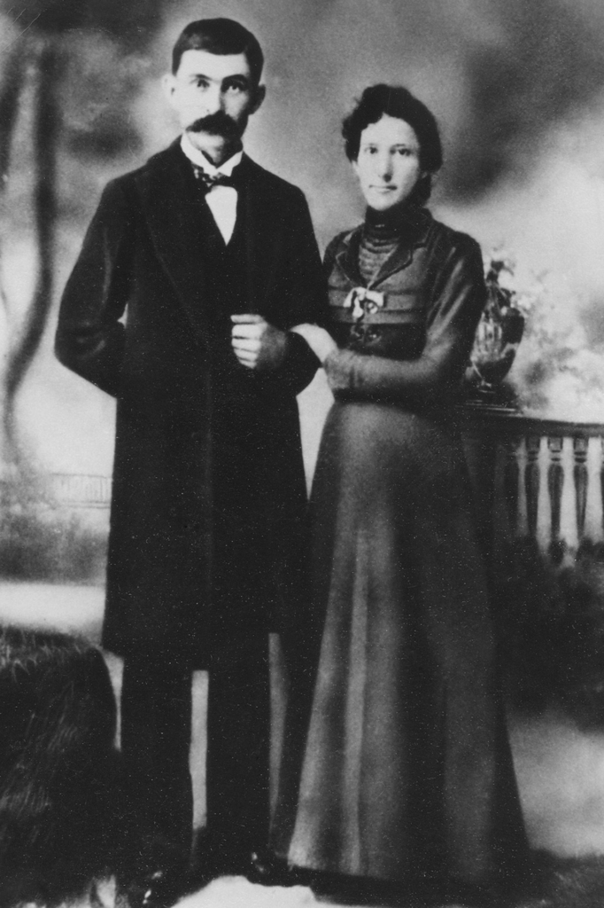 Archival portrait of William Warren Melott and Rose Myrtle Sherwin. They stand with arms linked at the elbow and are wearing formal dress.