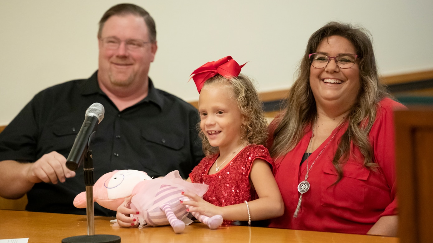 Jackie, Adalynn Grace, and Scherry Climer smile from their seats in the Tribal courtroom as Adalynn Grace's adoption is finalized.