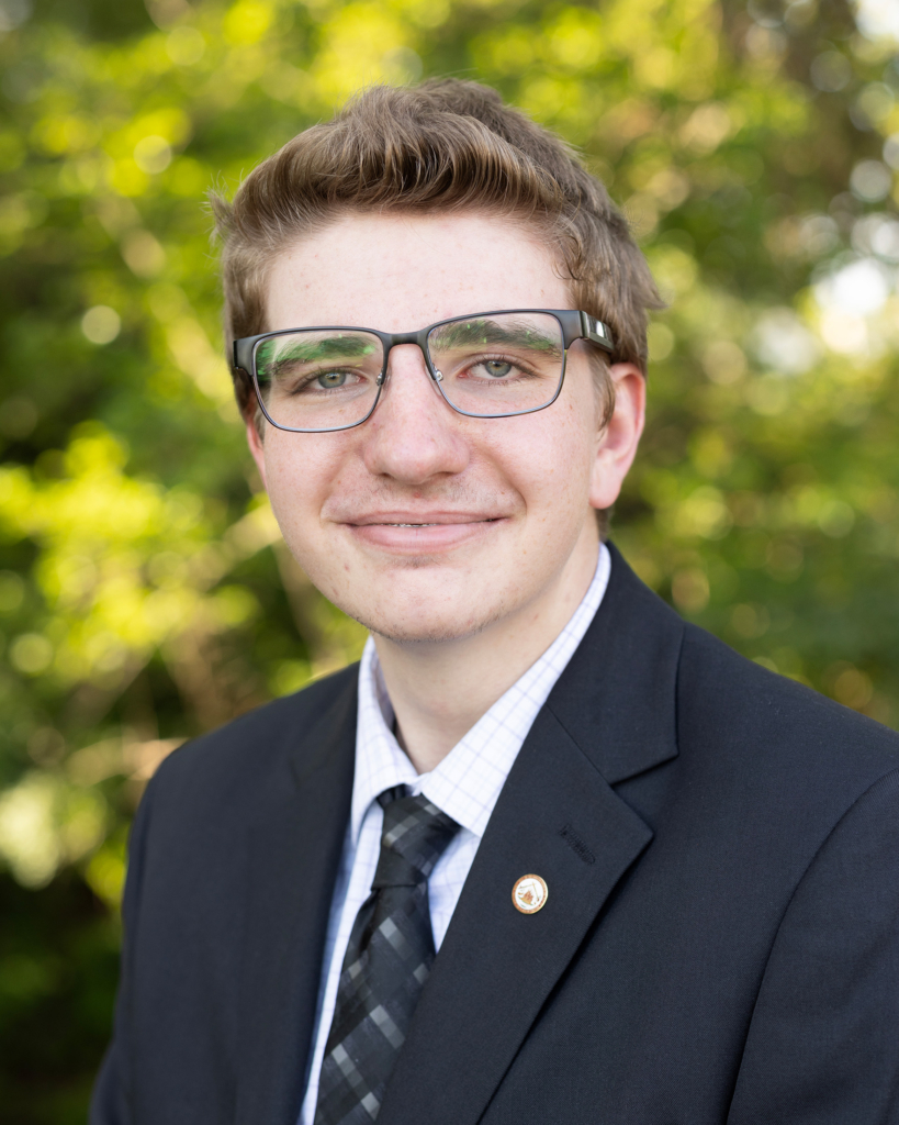 Headshot of Tribal member Issak Decker wearing a suit and tie.