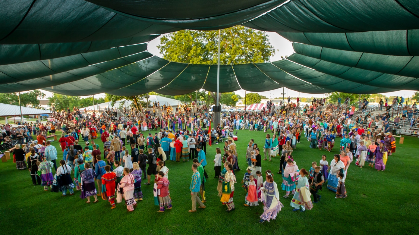 Wide angle shot of the arena during Grand Entry at the 2019 CPN Family Reunion Festival.