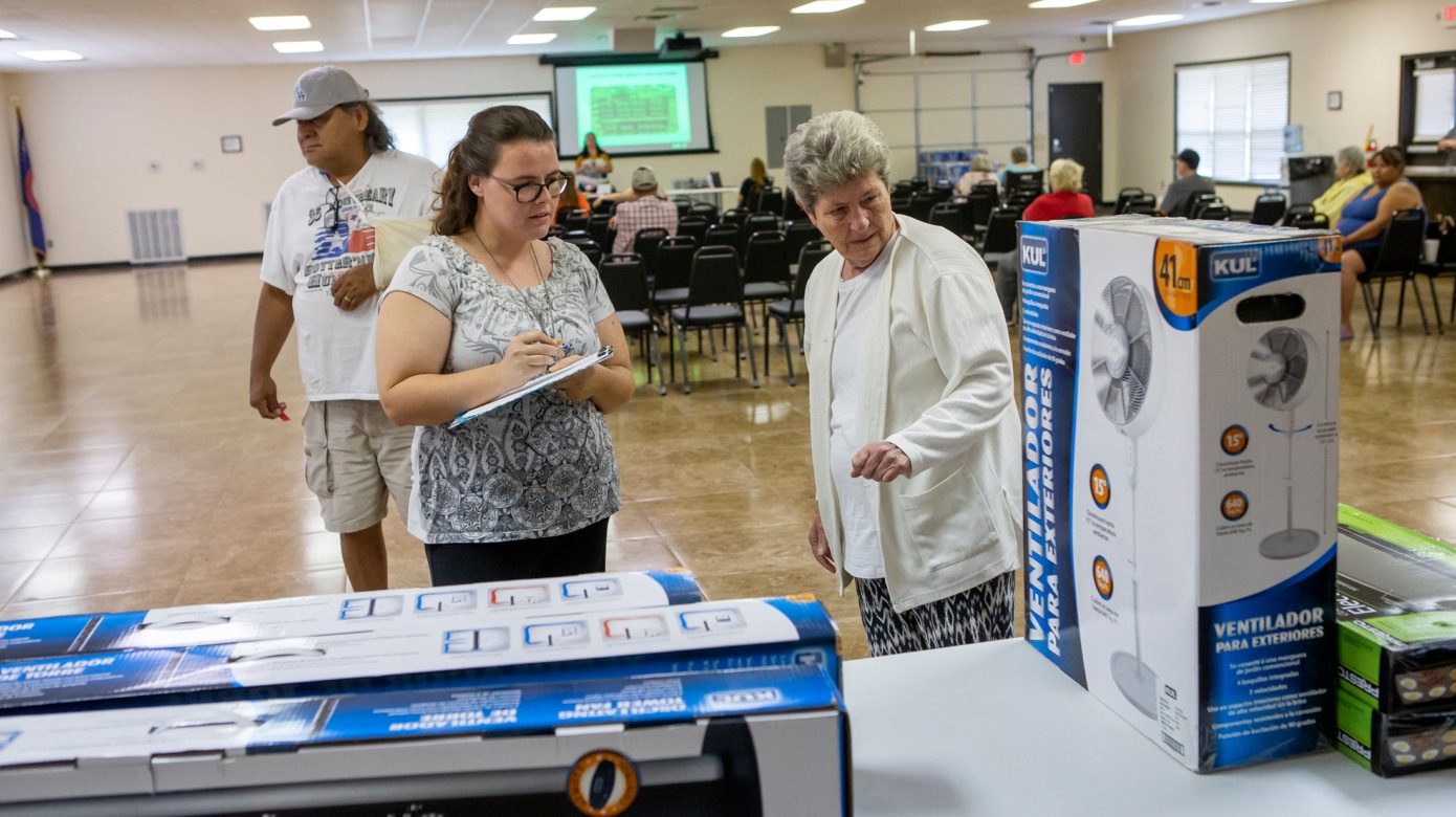 Participants browse tables of tower fans and other home heat and air appliances at a CPN LIHEAP community education event.
