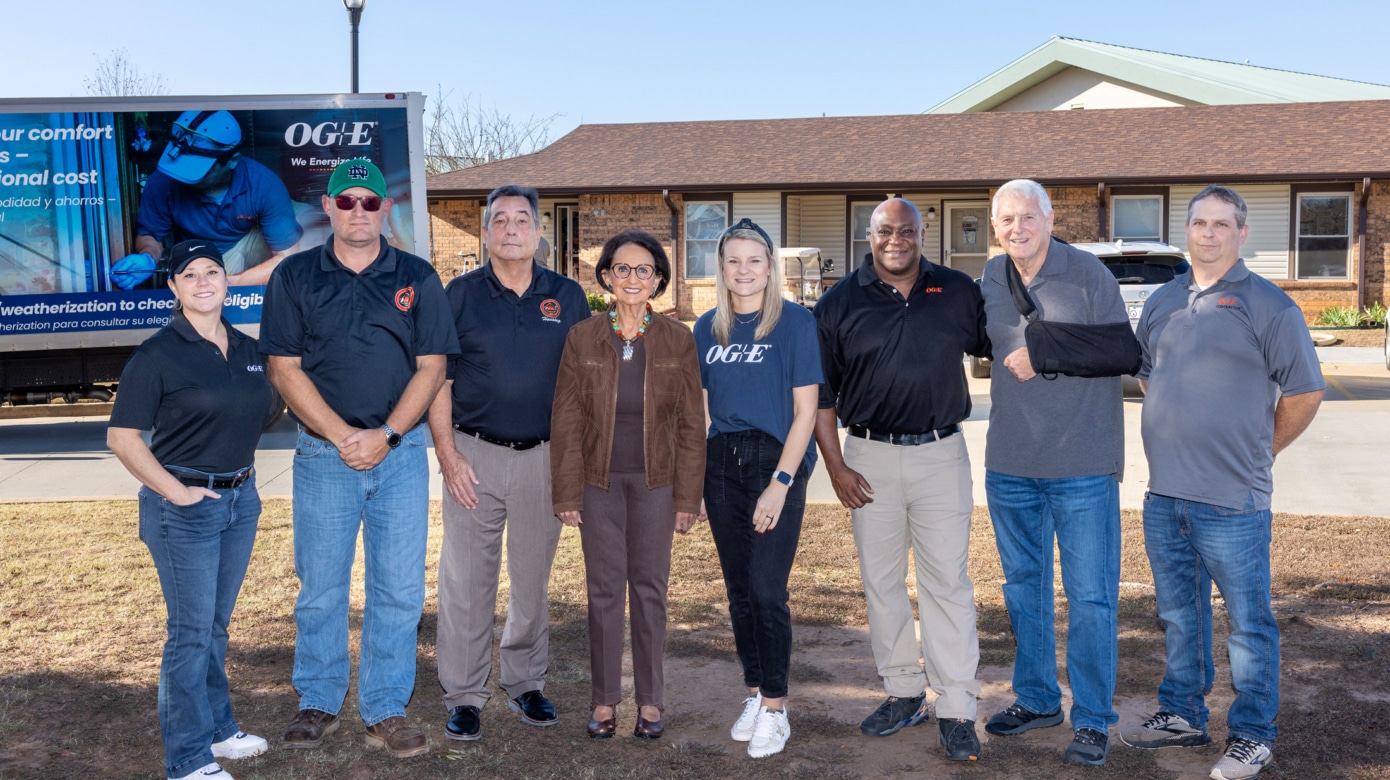 Group photo in front of an OG&E box truck and a duplex in the CPN Elder living complex.