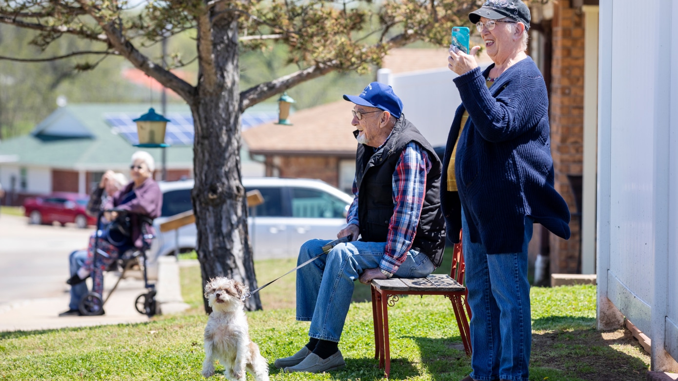 Gene and Linda Renegar watch with their dog, Gypsy Rose, during a parade at the CPN Elder Living Complex.