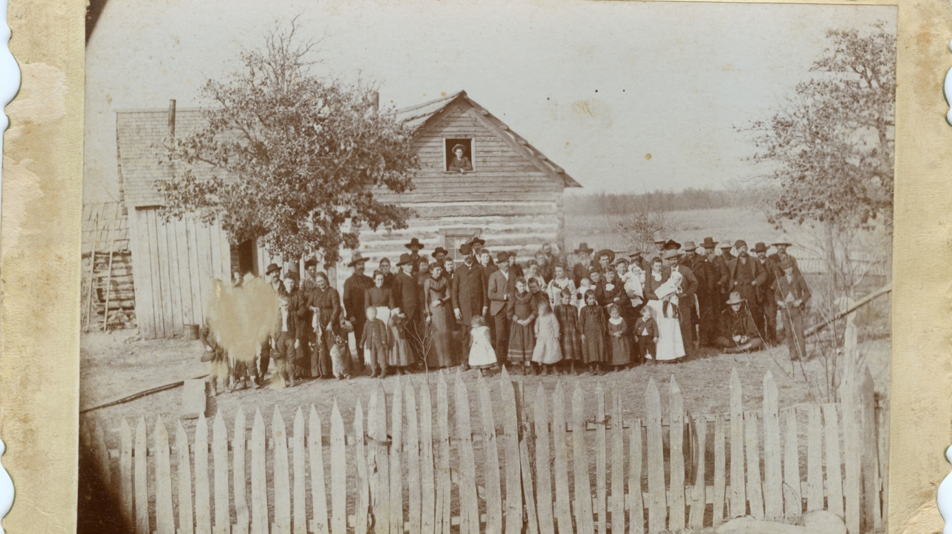 A sepia toned and faded photograph of the family gathered at Joseph Andrew Nadeau and Sarah Catherine Tescier's wedding at Sarah's mother's home in St. Marys, Kansas, in 1884.