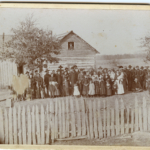 A sepia toned and faded photograph of the family gathered at Joseph Andrew Nadeau and Sarah Catherine Tescier's wedding at Sarah's mother's home in St. Marys, Kansas, in 1884.